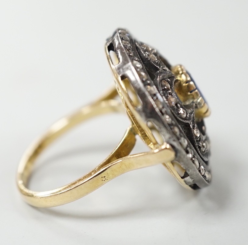 An Indian pierced yellow metal, sapphire and rose cut diamond set circular cluster ring, size N/O, gross weight 8.4 grams.